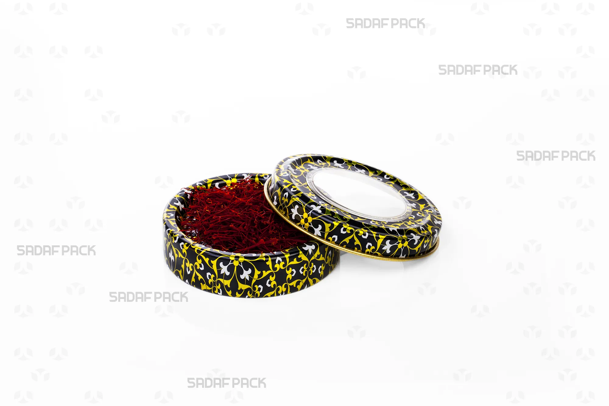 A top-down shot of the Sadaf Pack 3 gram metal tin (Black, Gold, and White design), open and filled with saffron to highlight the container's capacity and elegant pattern.