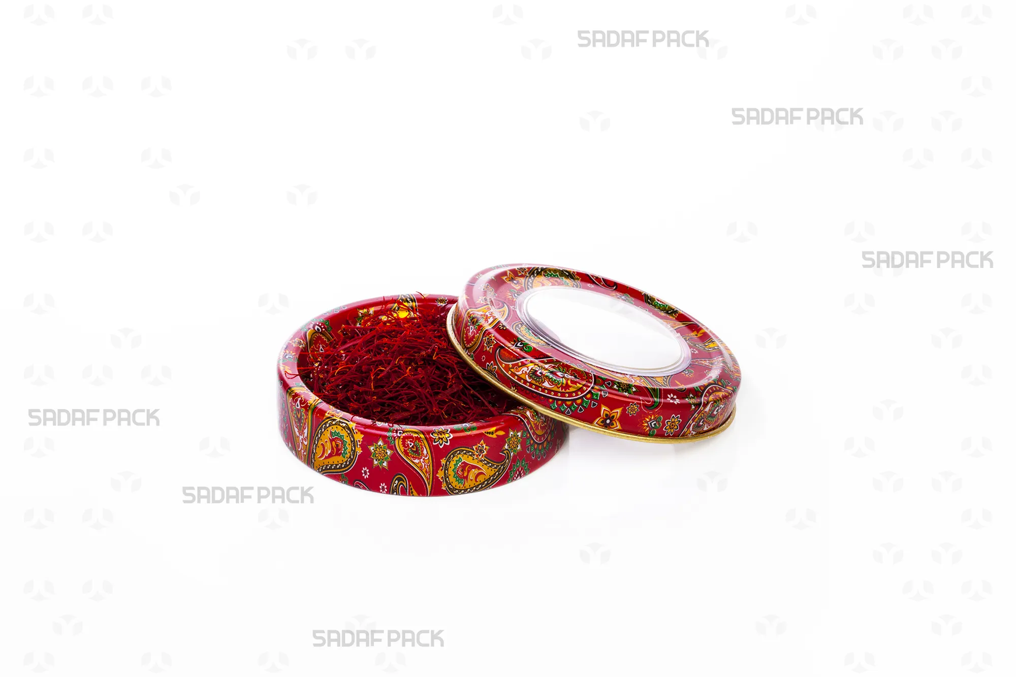 Top view of the Sadaf Pack 3 gram metal tin, showcasing the red Termeh pattern, filled with saffron threads with the lid open to the side.