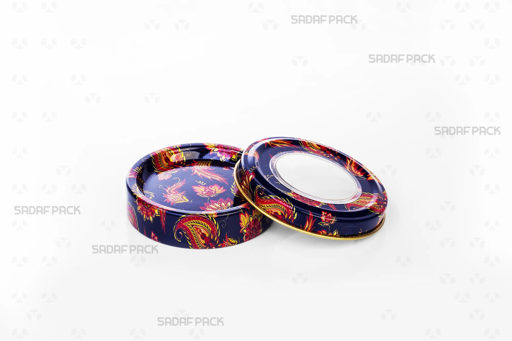 An overhead shot of the empty 3 gram metal tin by Sadaf Pack (navy Toranj design) with the lid placed beside it, clearly showing the internal depth and design.