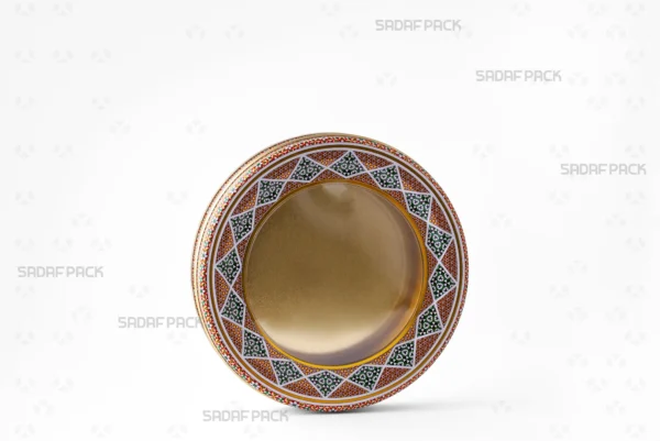 Three-quarter view of the 17 Metal 2 cm circular tin, a wide, shallow metal container by Sadaf Pack.