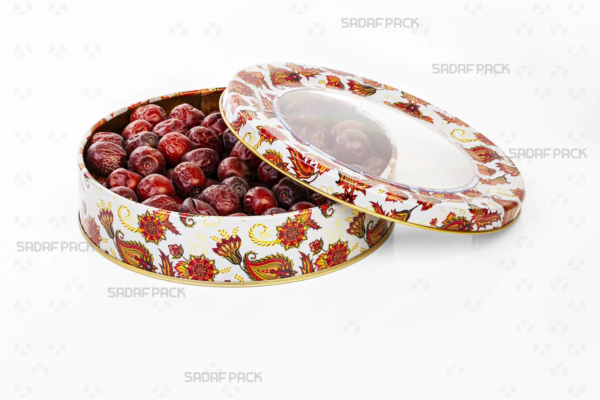 Top-down view of the Sadaf Pack 17cm x 3cm round metal tin, showing the open lid and base with the white Toranj design, filled with dried jujubes to display internal capacity.
