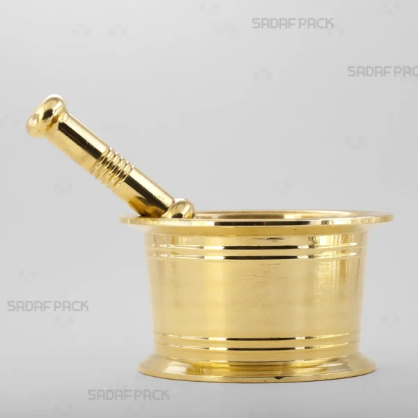 A front view of the Sadaf Pack Traditional Brass Mortar 110, showcasing its sturdy, cylindrical design and the detailed circular lines engraved on its heavy brass body, perfect for grinding saffron and various spices.