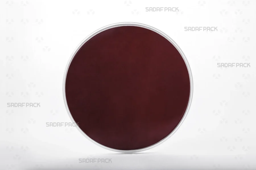 Three-quarter angle view of the 15 slim España round poly-crystal container with crimson Cardboard Pad 15 inside container