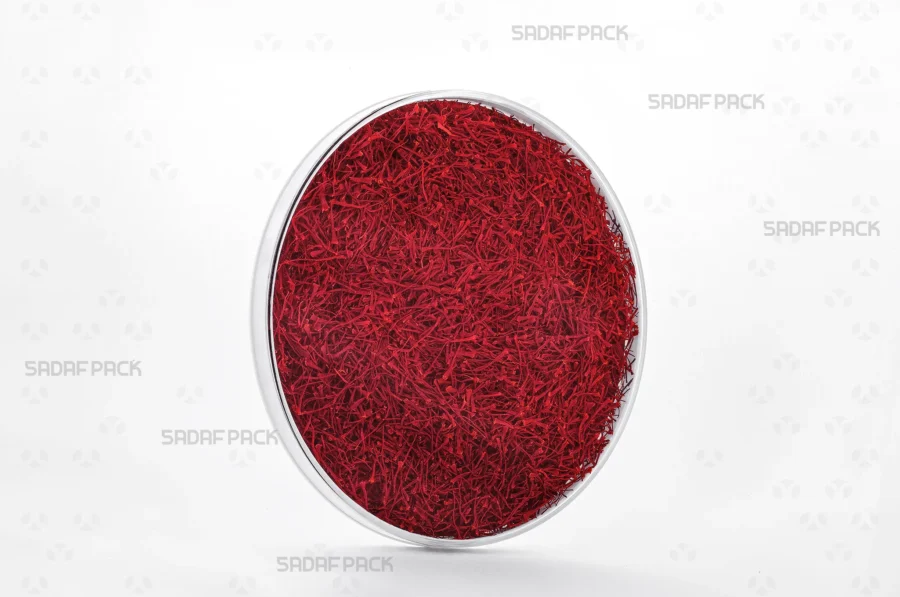 A three-quarter angle view of the 15 Slim España container filled with saffron, demonstrating its capacity for luxury food items suitable for export.