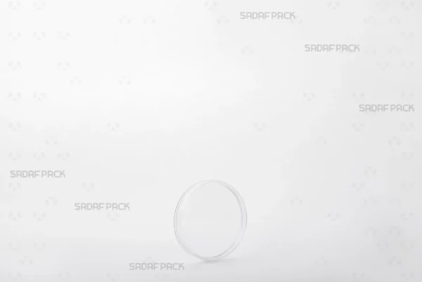 A three-quarter angle view of the elegant 5 Flat Crystal container by Sadaf Pack, showcasing its circular, low-profile design ideal for premium saffron.