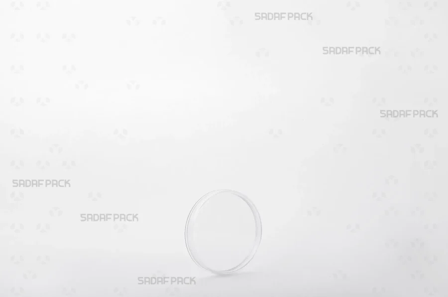 A three-quarter angle view of the elegant 5 Flat Crystal container by Sadaf Pack, showcasing its circular, low-profile design ideal for premium saffron.