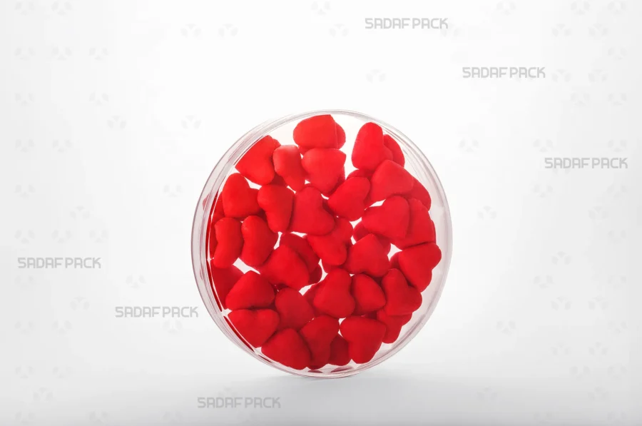 A three-quarter angle view of the 12 Core Crystal Container filled with Red candies, demonstrating its suitability for export-quality packaging.