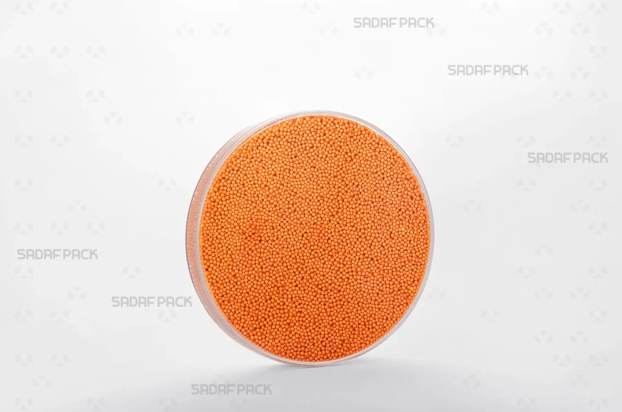A three-quarter angle view of the 12 Core Crystal Container filled with nonpareils, demonstrating its suitability for export-quality packaging.