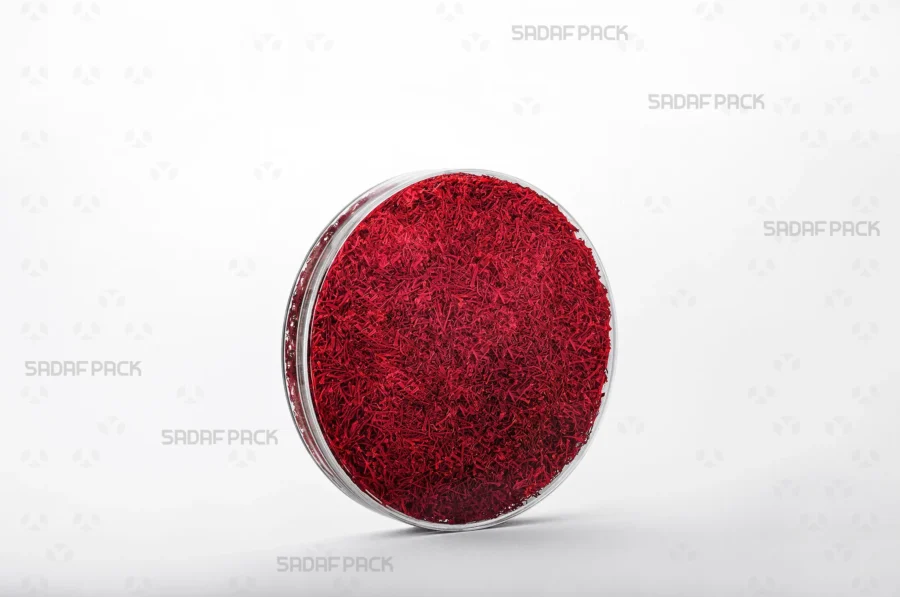A three-quarter angle view of the 12 Core Crystal Container filled with saffron, demonstrating its suitability for export-quality packaging.