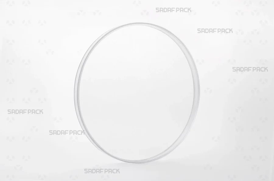 Three-quarter view of the 15 Flat Crystal container by Sadaf Pack, a circular polycrystal container for luxury saffron packaging.