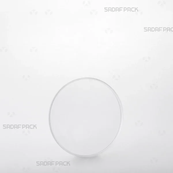 A three-quarter angle view of the 9.5 Flat Crystal container by Sadaf Pack, showcasing its clear, circular design ideal for premium saffron packaging.