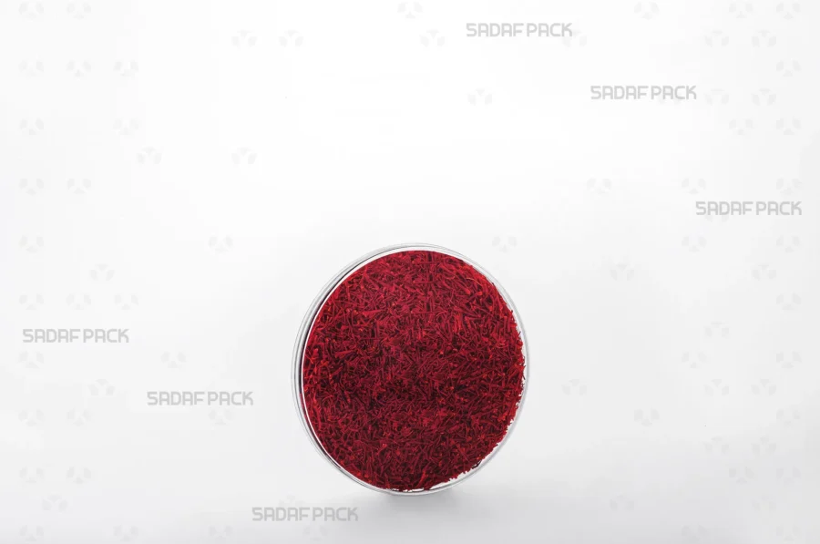 An elegant three-quarter view of the 9.5 Flat Crystal container filled with high-quality saffron, demonstrating its excellent product visibility for export markets.