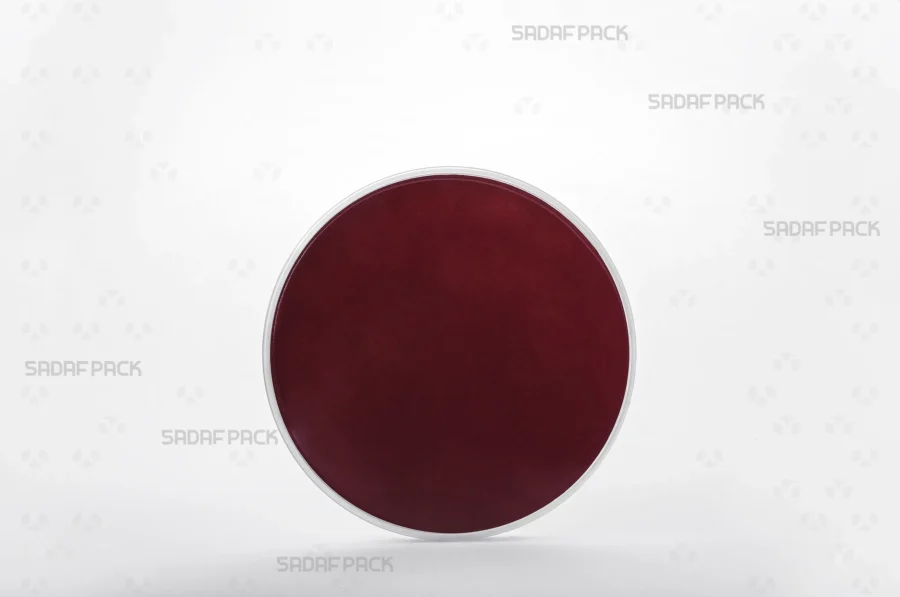 A three-quarter view of the 12 Medium España container filled with crimson Cardboard Pad