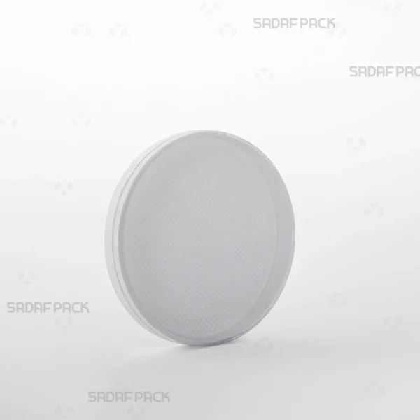 Three-quarter angle view of the round 9 España crystal container from Sadaf Pack, designed for premium saffron packaging.