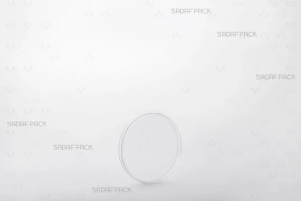 Three-quarter view of the 6.5 Flat Crystal container by Sadaf Pack, a circular container designed for premium saffron and spice packaging.