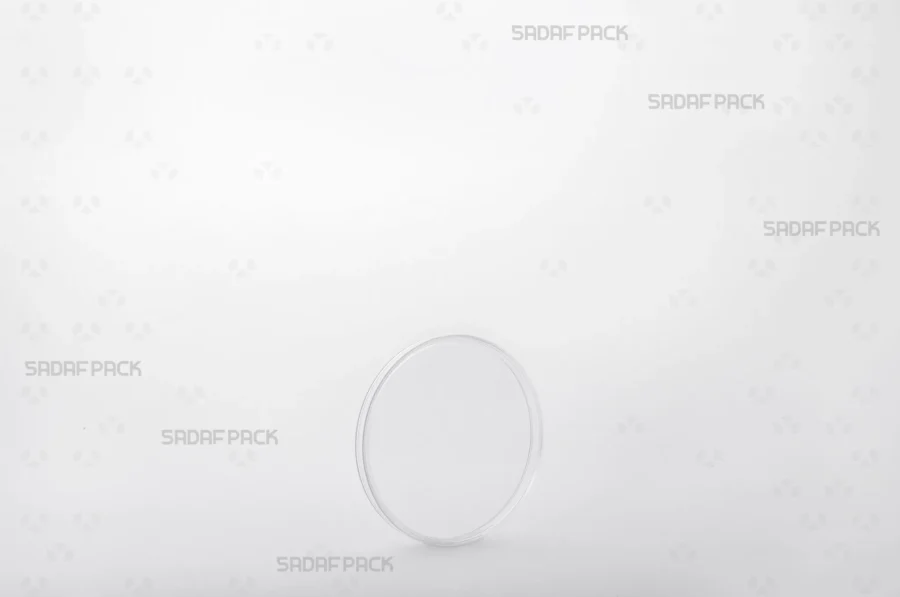 Three-quarter view of the 6.5 Flat Crystal container by Sadaf Pack, a circular container designed for premium saffron and spice packaging.