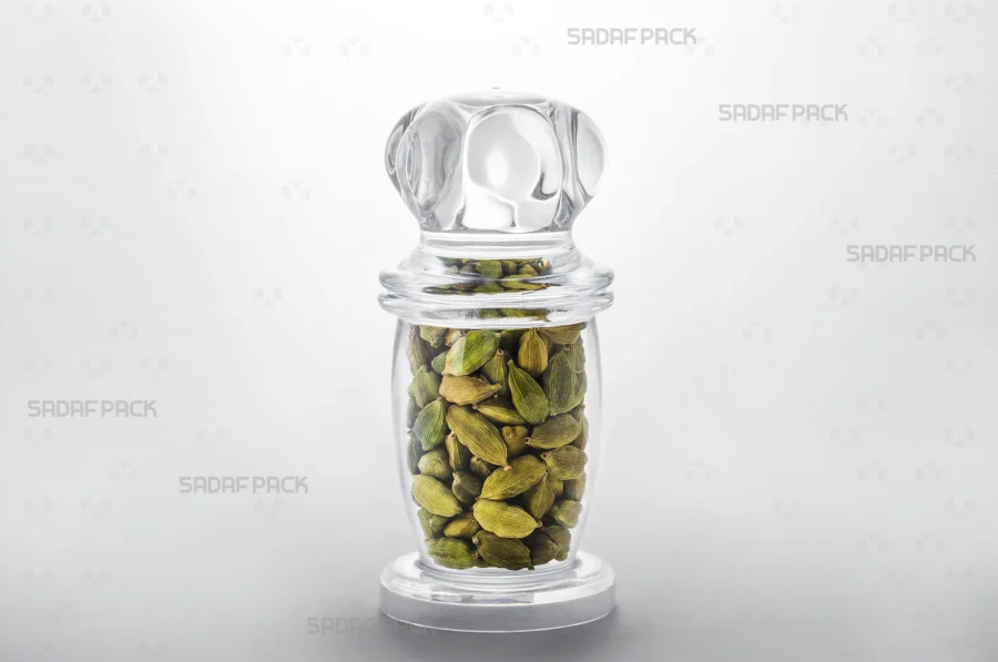 A Milad 4 crystal container filled with cardamom, demonstrating its suitability for exporting high-value food products.