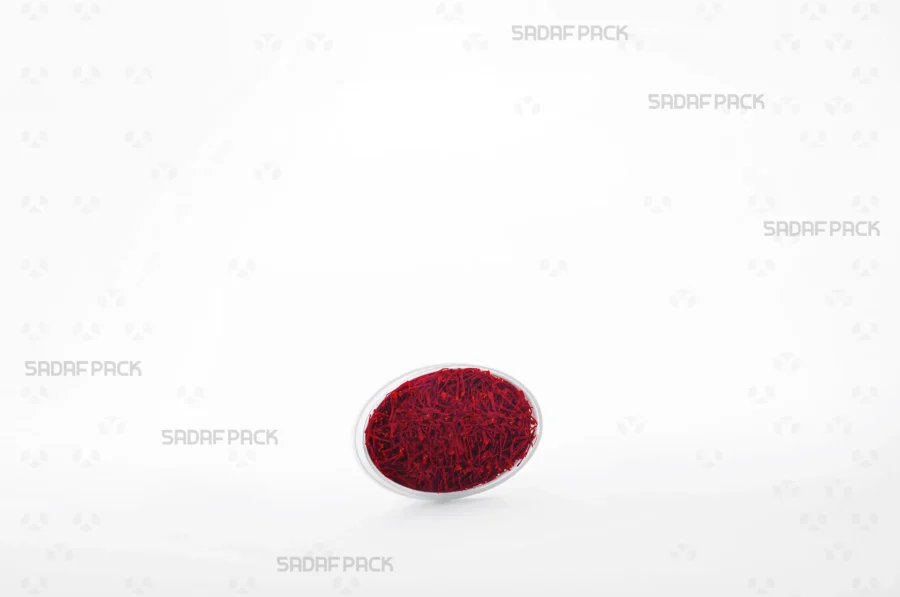The sophisticated Oval 2 España container filled with high-quality saffron, making it a perfect choice for export and luxury retail presentation.