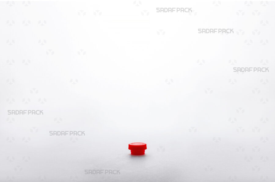 A detailed three-quarter angle view of the Powder Short Red container's lid, emphasizing its secure closure mechanism and smooth finish.