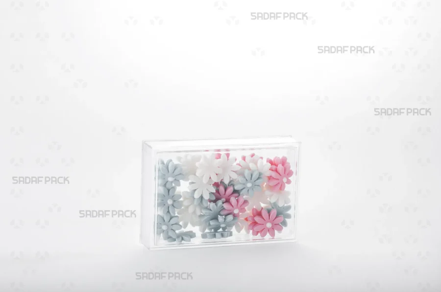 A three-quarter angle view of the 11.5 Crystal Rectangle container filled with decorative suger, demonstrating its suitability for high-value export goods.