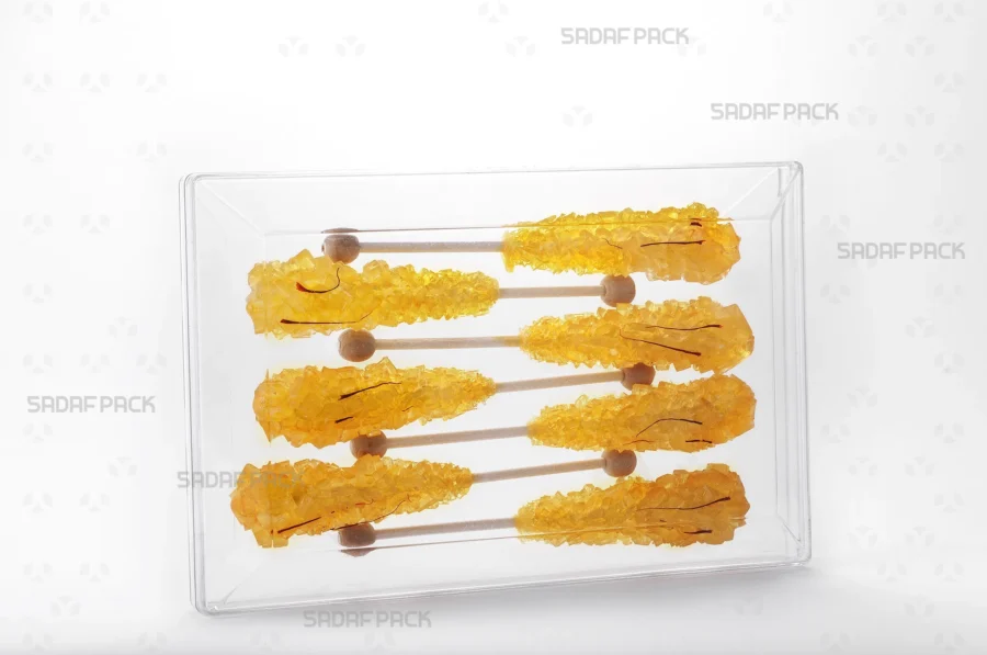 The Rectangle 200 container filled with saffron rock candy, showcasing its excellent clarity for premium product presentation suitable for export.
