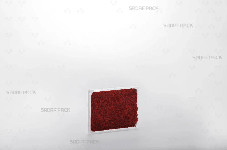 A three-quarter angle view of the Rectangle 7 Slim Crystal container filled with saffron, demonstrating its suitability for export and high-end retail display. 