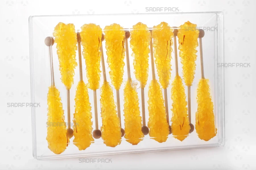The elegant Rectangle 300 container filled with an assortment of saffron rock candy, demonstrating its excellent product visibility and suitability for export gift packaging.