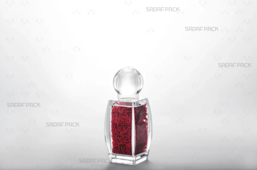 A three-quarter view of the Sadaf 2 luxury container filled with saffron, showcasing its excellent transparency for export-quality goods.