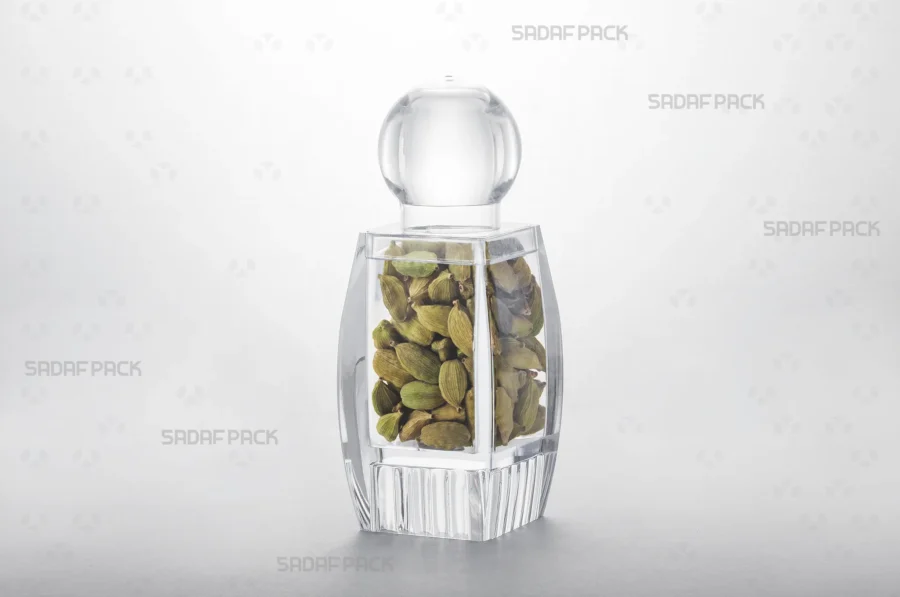 The Sadaf 4 Raised Bottom crystal container filled with cardamom, showcasing its suitability for premium export packaging.