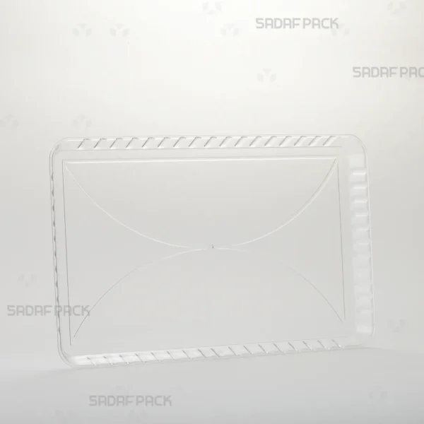 A three-quarter angle view of the Crystal Rectangle Tray 100 by Sadaf Pack, showcasing its elegant design for premium confections.