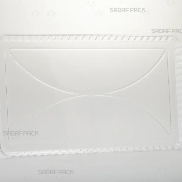 A three-quarter angle view of the Crystal Rectangle Tray 150 by Sadaf Pack, showcasing its clear polycrystal material and rectangular shape. This tray is designed for elegant presentation of sweets, rock candy, and gifts.