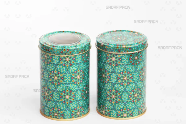 A side-by-side comparison in a three-quarter view of two Sadaf Pack 7cm by 10cm metal tins with the Turquoise (Firoozeh) pattern, both closed, showing the version with a polycrystal window lid and the version with a solid lid.