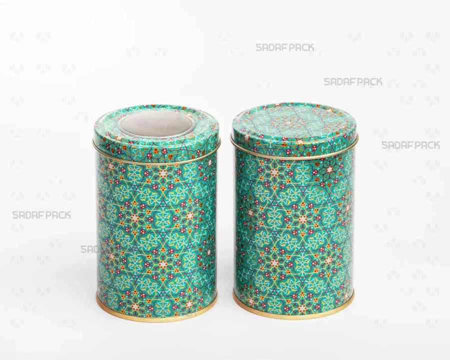 A side-by-side comparison in a three-quarter view of two Sadaf Pack 7cm by 10cm metal tins with the Turquoise (Firoozeh) pattern, both closed, showing the version with a polycrystal window lid and the version with a solid lid.