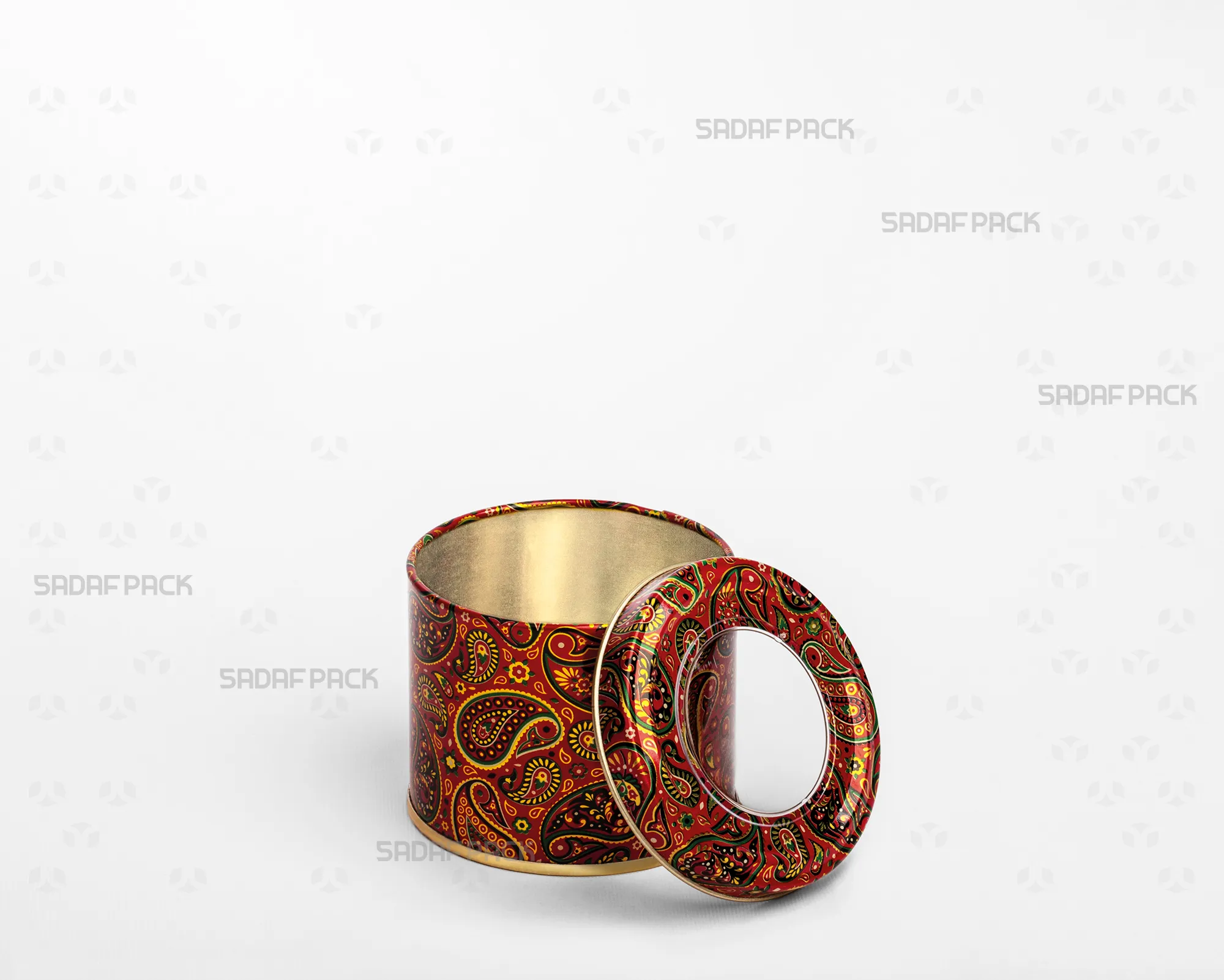 A three-quarter angle view of the Sadaf Pack 7cm diameter by 5cm height metal tin with an open lid, showcasing the Red Termeh pattern and the clear polycrystal window on the separated lid.