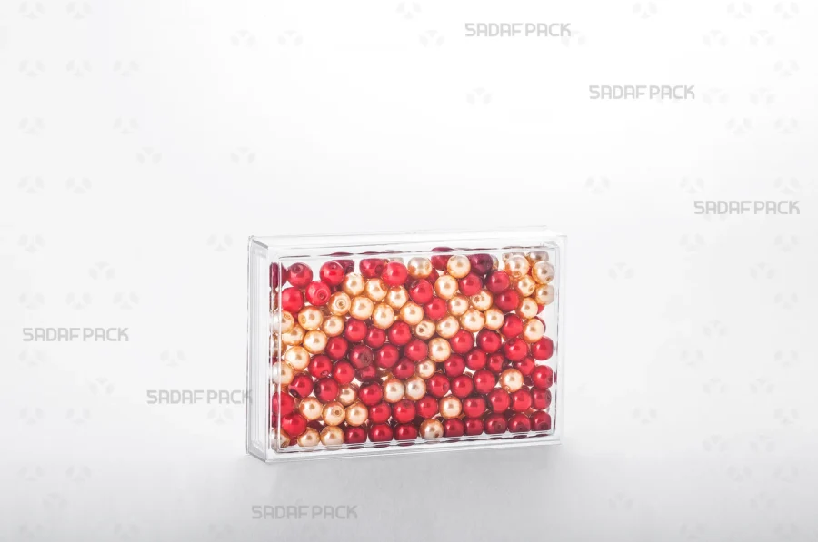 The 12.5 Crystal rectangular container filled with beads, demonstrating its use for high-value, export-quality products.