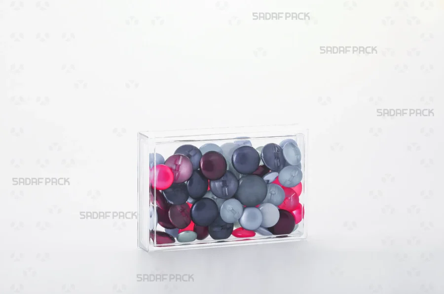 The 12.5 Crystal rectangular container filled with buttons, demonstrating its use for high-value, export-quality products.