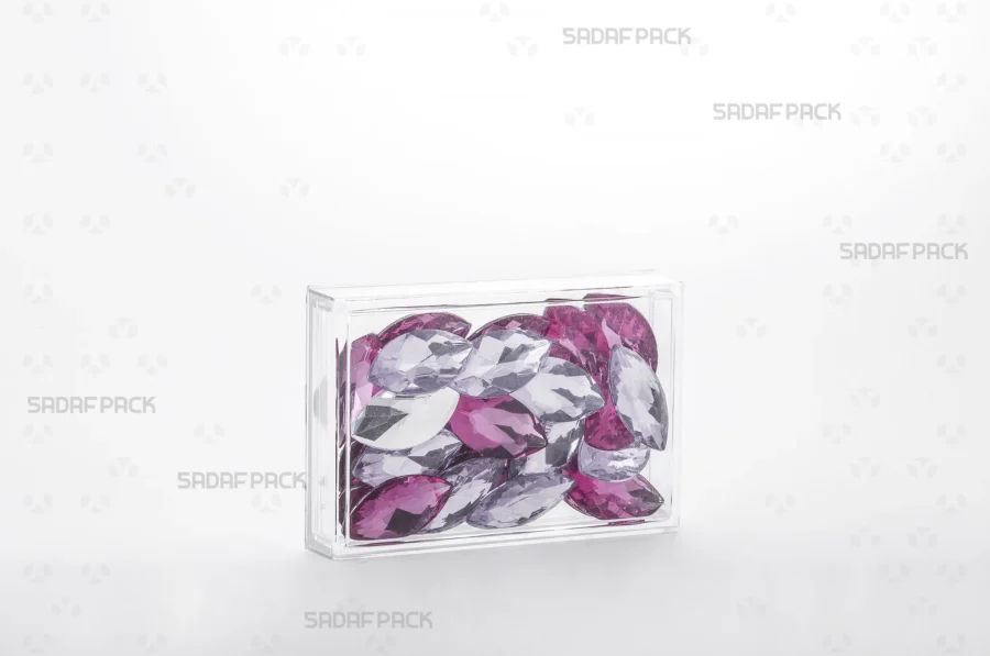 The 12.5 Crystal rectangular container filled with glass Cabochons, demonstrating its use for high-value, export-quality products.