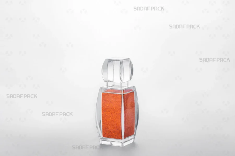 The Azin 2 crystal container filled with vibrant red chili powder, demonstrating its use as an elegant and protective packaging solution for export. 