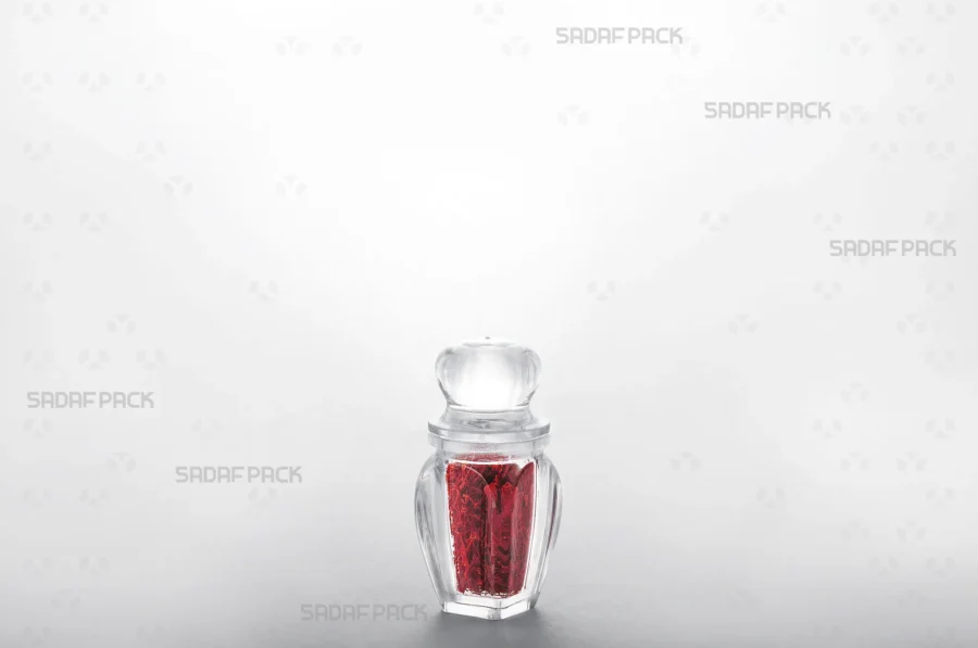 The Gohar 1 Crystal Container filled with vibrant red saffron, demonstrating its excellent transparency for showcasing premium export-quality products. 