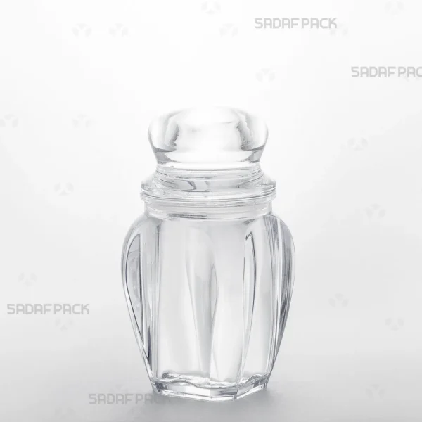 A three-quarter angle view of the Gohar 4 crystal container by Sadaf Pack, showcasing its clarity and elegant design for premium saffron packaging.