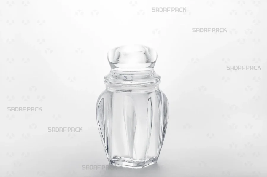 A three-quarter angle view of the Gohar 4 crystal container by Sadaf Pack, showcasing its clarity and elegant design for premium saffron packaging.
