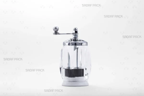 A front view of the Sadaf Pack Four Corners Crystal Saffron Grinder, showcasing its transparent square-shaped body, chrome-plated rotary handle and cap, and its efficient mechanism designed for grinding saffron threads into a fine, uniform powder.