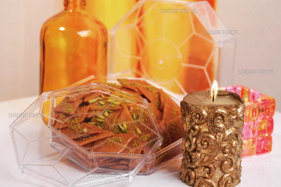 A three-quarter angle view of the Sadaf Pack Octangular crystal container filled with authentic Sohan sweets, showcasing its elegant design suitable for premium export and gift packaging.