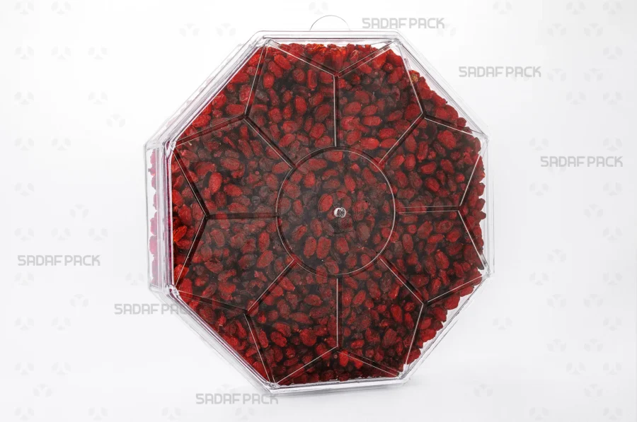 A three-quarter angle view of the Octagon Short container filled with Barberries, showcasing its suitability for luxury food exports. 