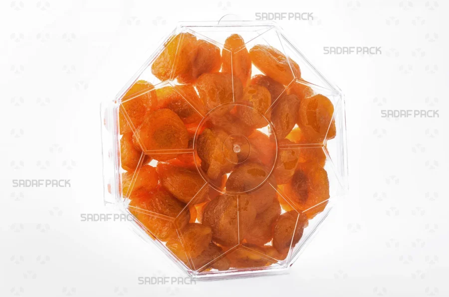 A three-quarter angle view of the Octagon Short container filled with Dried Prunes, showcasing its suitability for luxury food exports. 