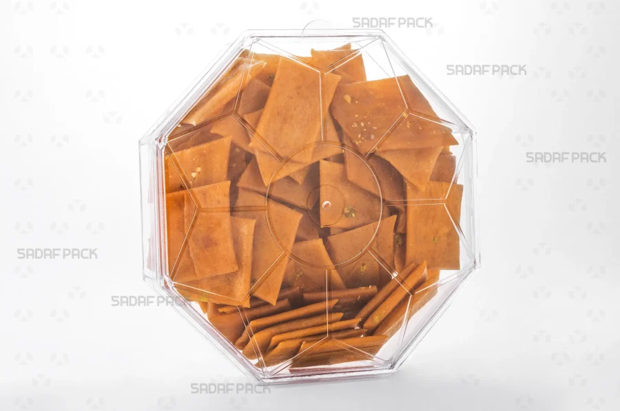 A three-quarter angle view of the Octagon Short container filled with Persian Saffron Brittle, showcasing its suitability for luxury food exports. 