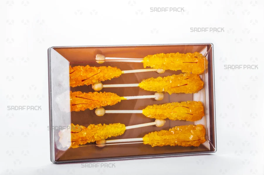 The luxurious Rectangle 200 Gold container filled with assorted saffron rock candy, ideal for premium gift packaging and export. 
