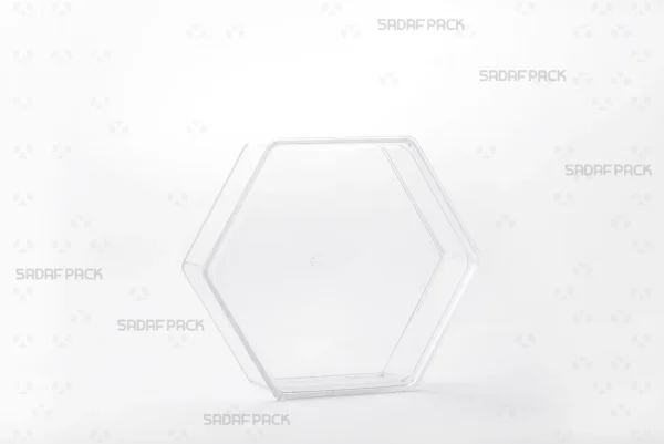 A three-quarter view of the Sadaf Pack Short Hexagonal Container, a clear polycrystal package ideal for luxury sweets and nuts.