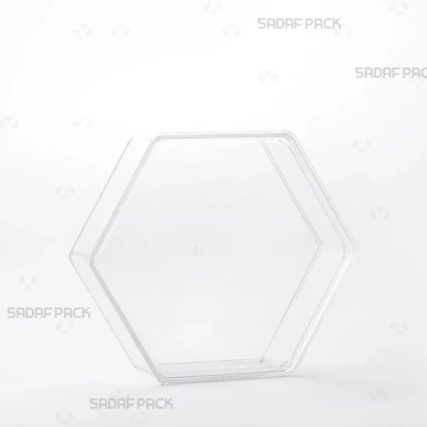 A three-quarter view of the Sadaf Pack Short Hexagonal Container, a clear polycrystal package ideal for luxury sweets and nuts.