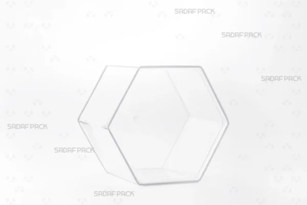 A three-quarter view of the Sadaf Pack Hexagon Tall crystal container, designed for premium packaging of sweets, nuts, and dried fruits.